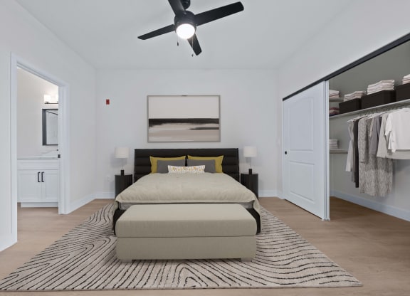 a bedroom with a bed and a ceiling fan